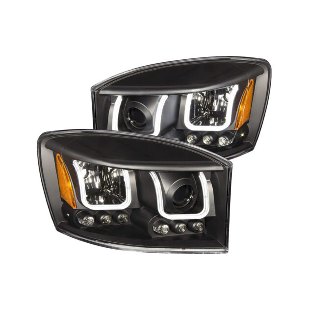 A pair of black headlights with orange lights.