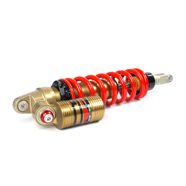 A red and gold shock absorber on a white background