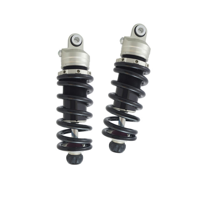 Two black and silver shock absorbers on a white background